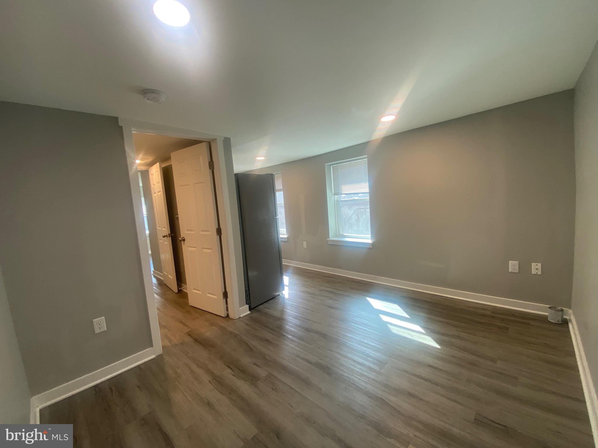 218 West King Street, Unit 3 Lancaster, PA 17603 - Photo 2 of 8 an empty room with wooden floor and windows
