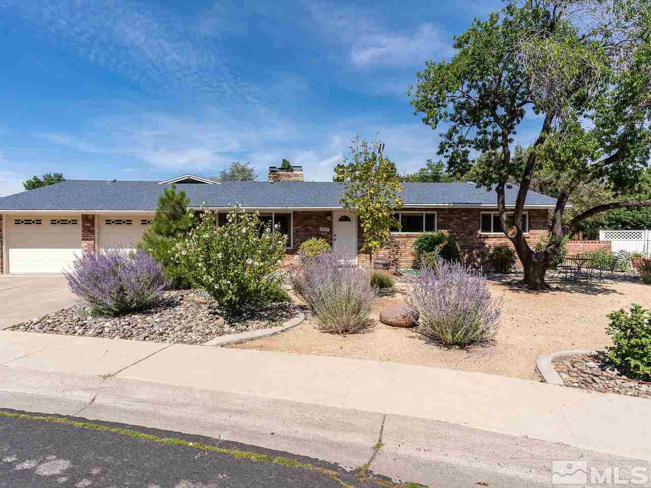 525 Harbin Lane Reno, NV 89509 - Photo 1 of 25 a view of a patio with a table and chairs under an umbrella