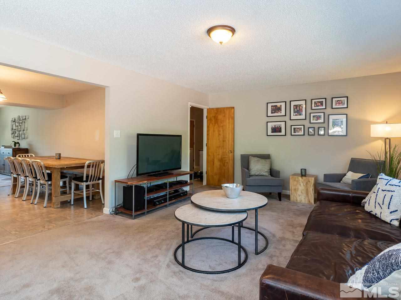 525 Harbin Lane Reno, NV 89509 - Photo 13 of 25 a living room with furniture a flat screen tv and a window