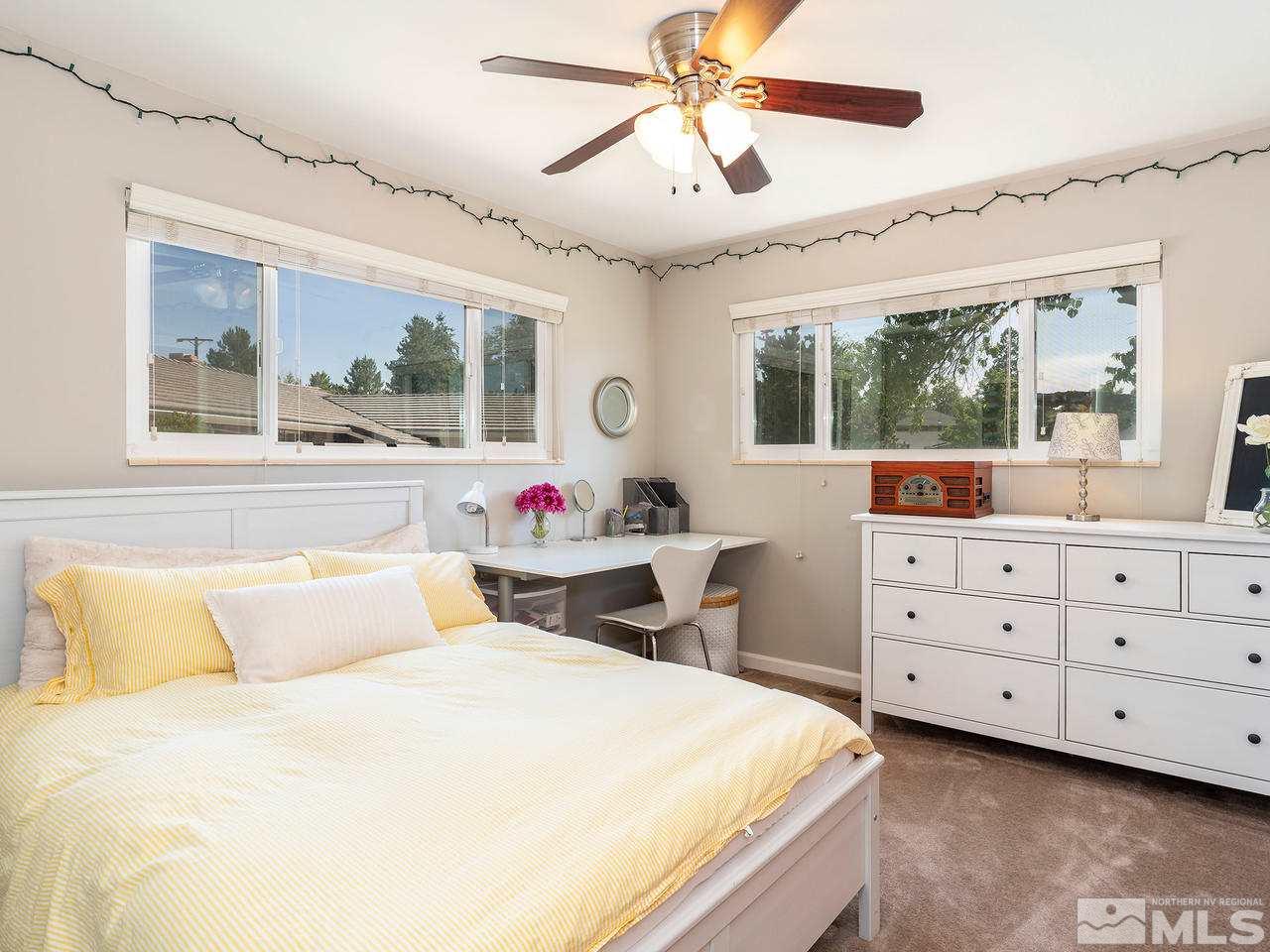 525 Harbin Lane Reno, NV 89509 - Photo 19 of 25 a bedroom with a bed and large windows