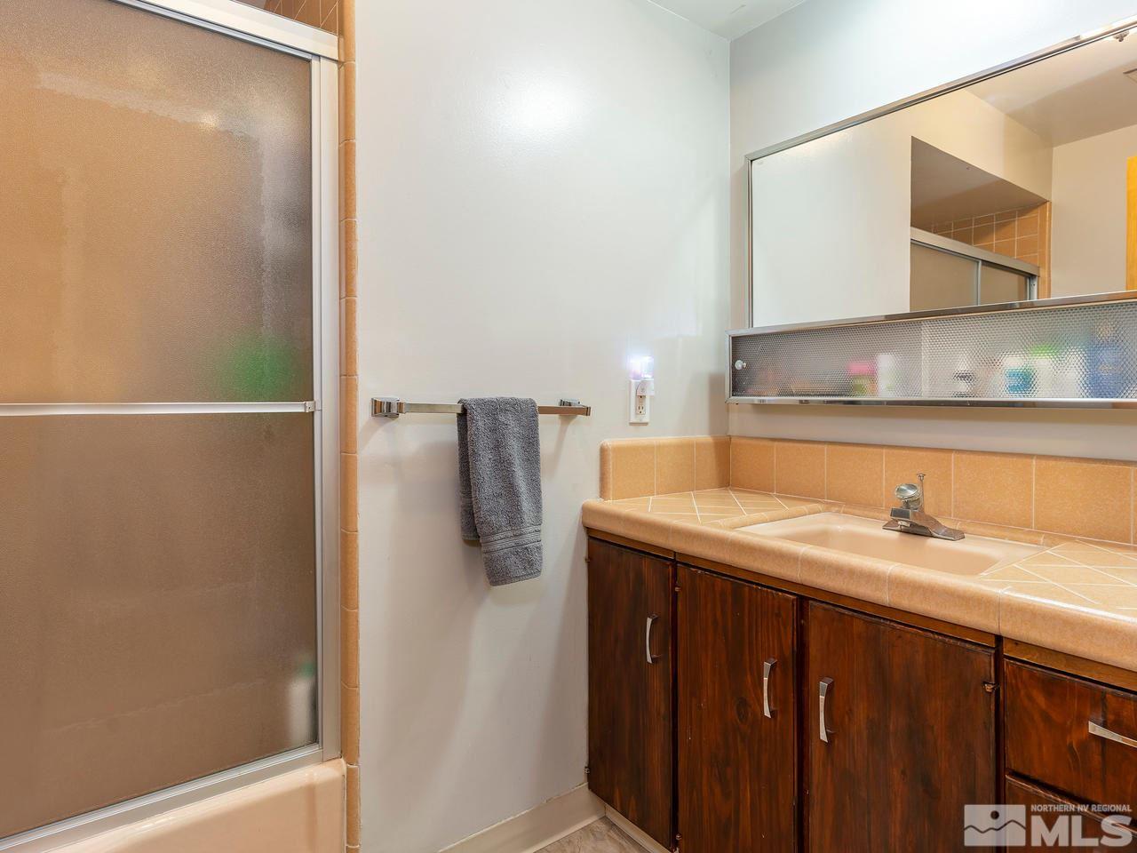 525 Harbin Lane Reno, NV 89509 - Photo 20 of 25 a bathroom with a sink and a mirror