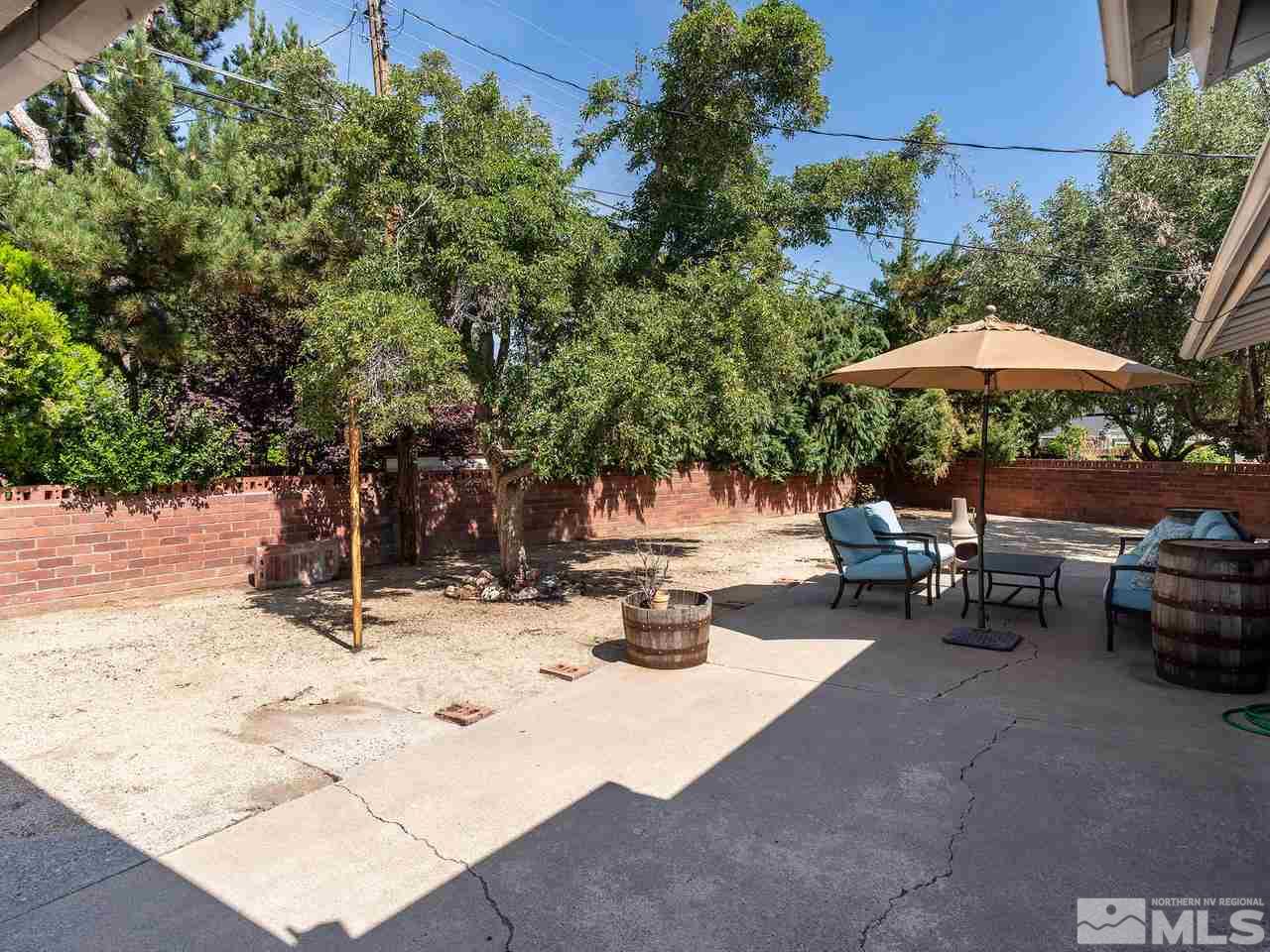 525 Harbin Lane Reno, NV 89509 - Photo 22 of 25 a view of backyard with outdoor seating and trees