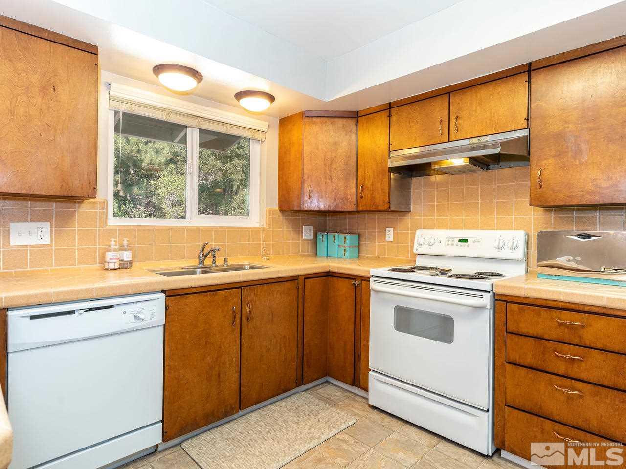 525 Harbin Lane Reno, NV 89509 - Photo 8 of 25 a kitchen with a sink cabinets and window