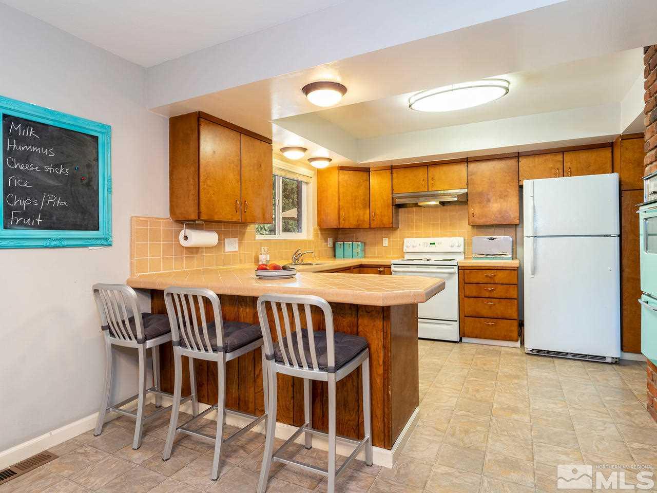 525 Harbin Lane Reno, NV 89509 - Photo 10 of 25 a large kitchen with a table and chairs in it