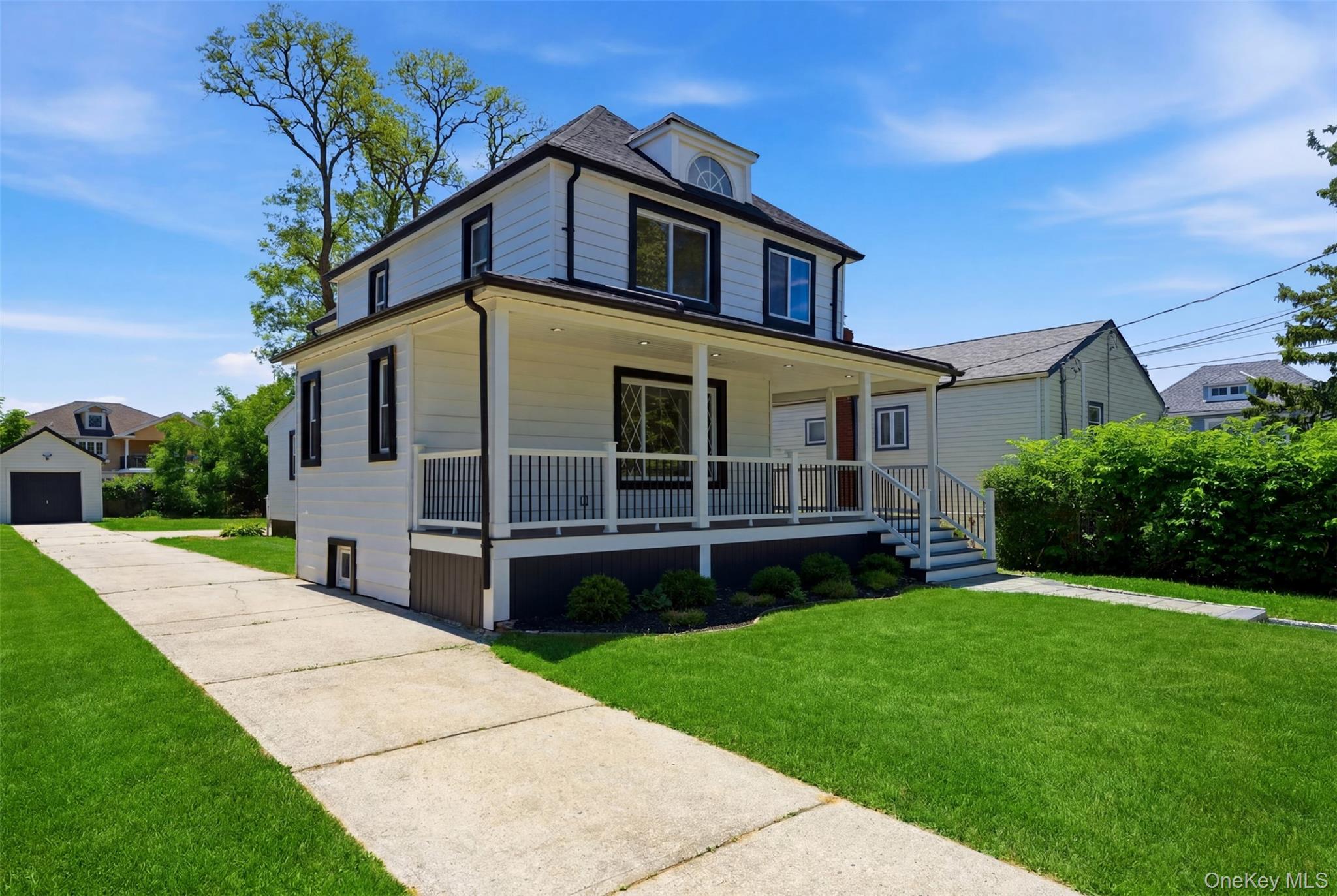 135 Whaley Street Freeport, NY 11520 - Photo 3 of 38 a front view of a house with a yard