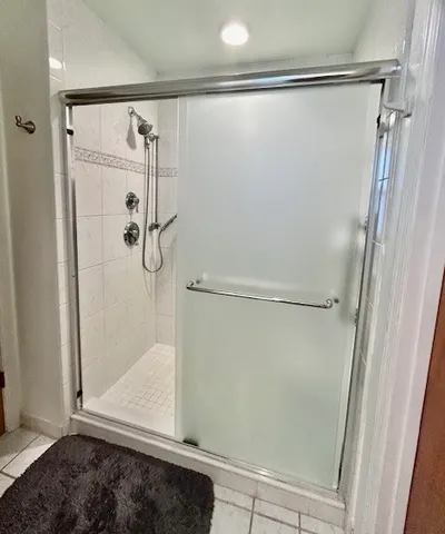 a bathroom with a glass shower door