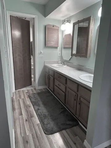 a bathroom with a double vanity sink and mirror