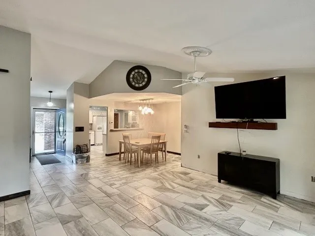 a view of a livingroom with furniture and a flat screen tv