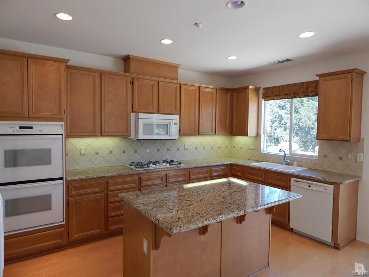 1402 Hidden Ranch Drive Simi Valley, CA 93063 - Photo 2 of 14 a kitchen with granite countertop a sink stainless steel appliances and cabinets