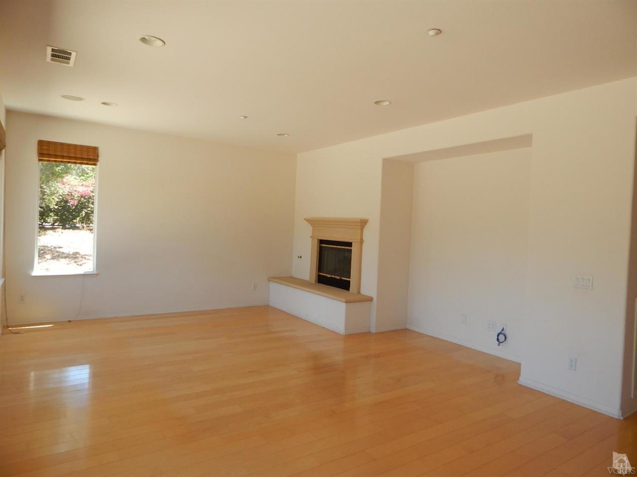1402 Hidden Ranch Drive Simi Valley, CA 93063 - Photo 3 of 14 an empty room with a fireplace and a window