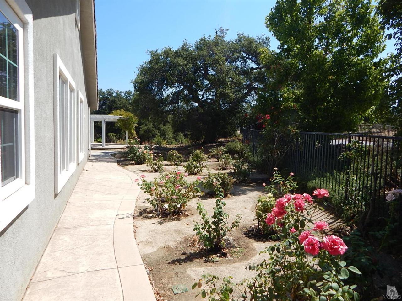 1402 Hidden Ranch Drive Simi Valley, CA 93063 - Photo 8 of 14 a front view of a house with a yard and fountain