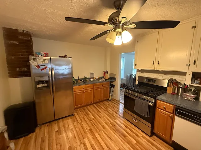 a kitchen with stainless steel appliances a stove a sink and a refrigerator