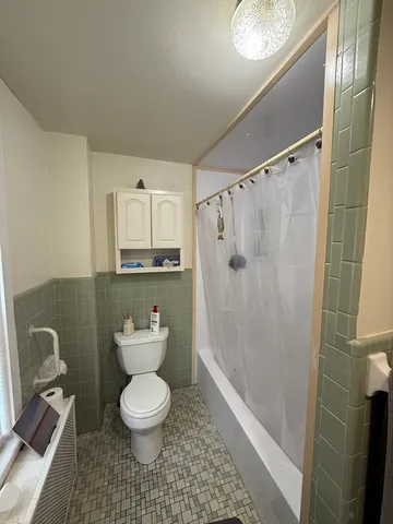 a bathroom with a toilet a sink and shower