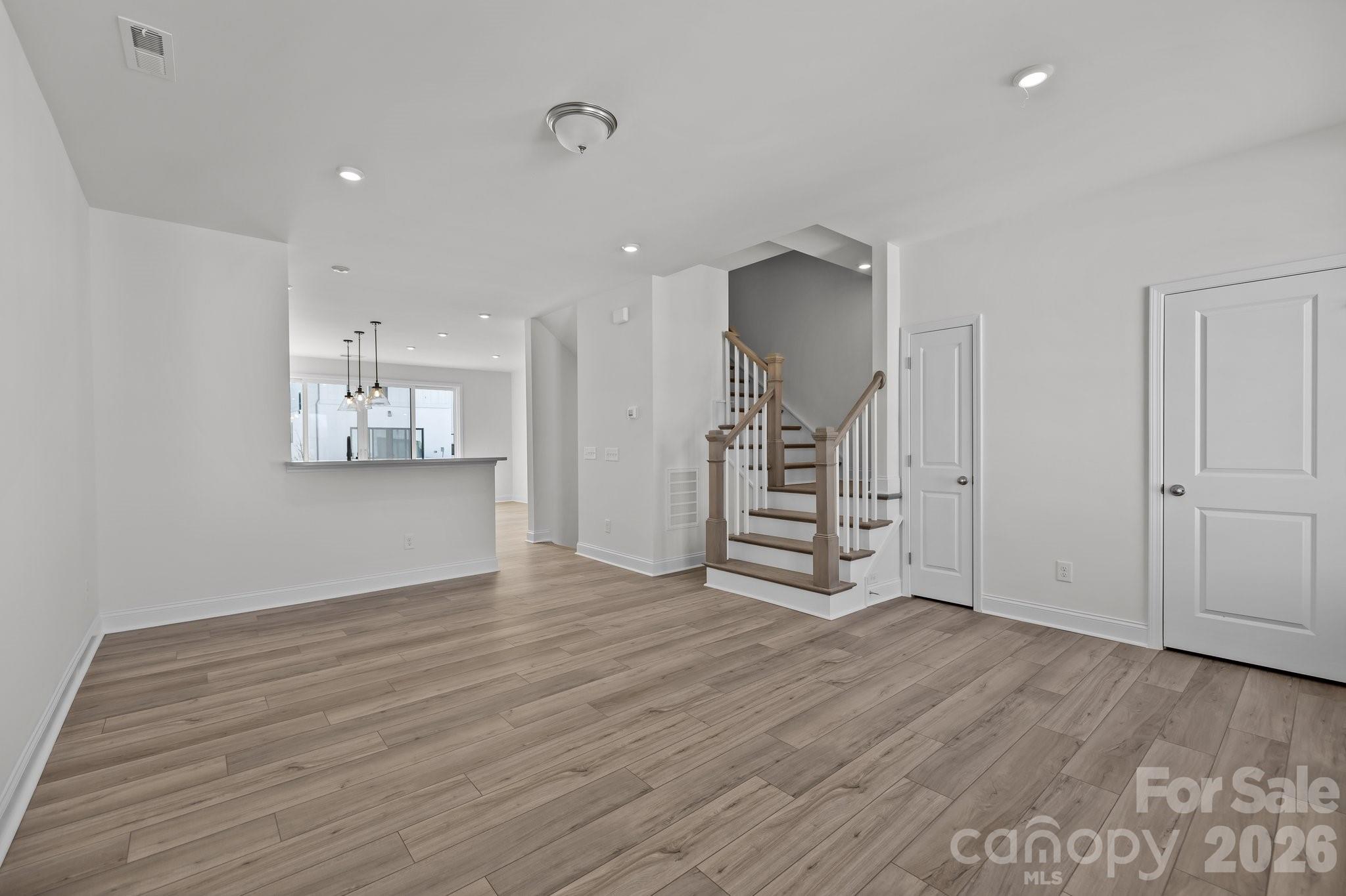 3021 Rozzelles Ferry Road Charlotte, NC 28208 - Photo 11 of 23 an empty room with wooden floor and windows