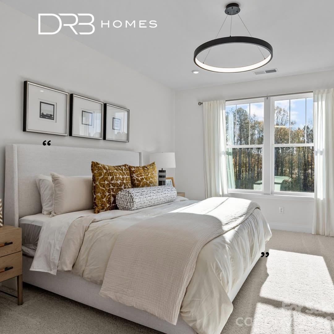 3021 Rozzelles Ferry Road Charlotte, NC 28208 - Photo 14 of 23 a bedroom with a large bed and a window