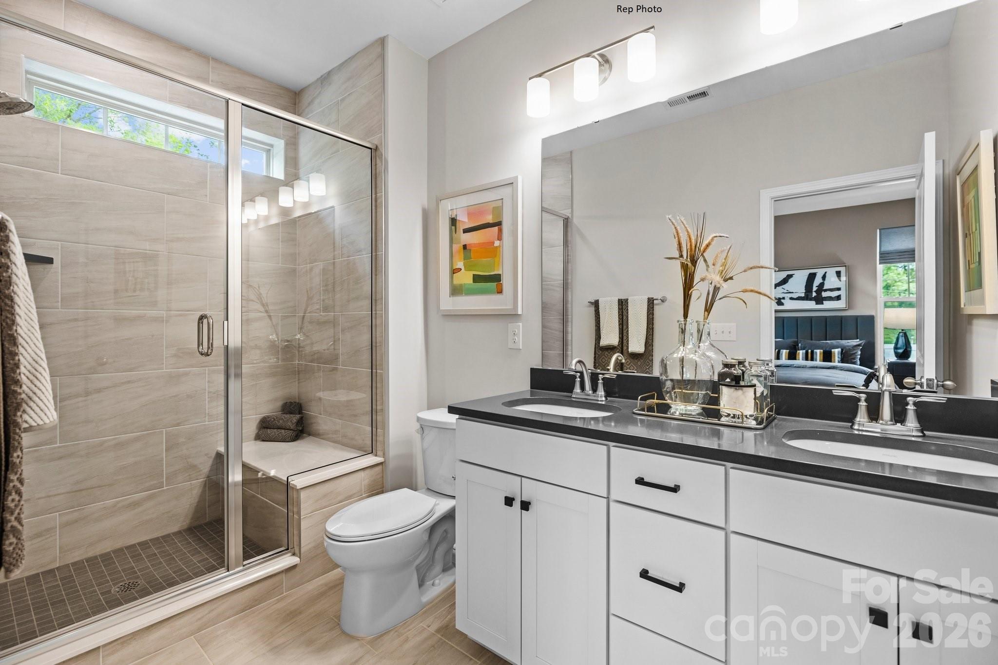 3021 Rozzelles Ferry Road Charlotte, NC 28208 - Photo 17 of 23 a bathroom with a granite countertop sink toilet a mirror and shower
