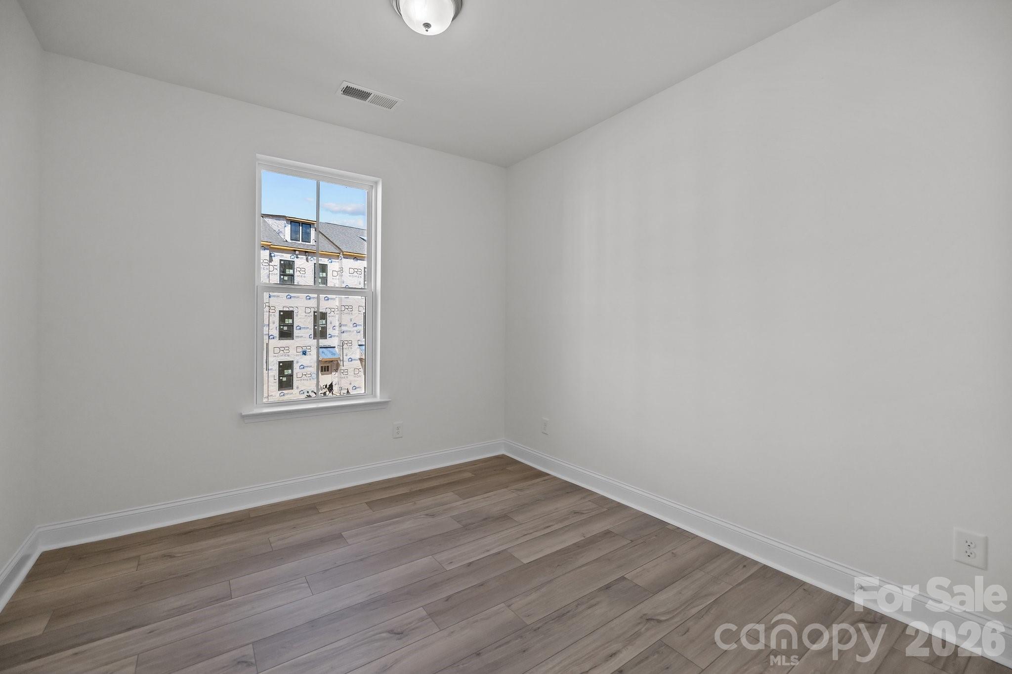 3021 Rozzelles Ferry Road Charlotte, NC 28208 - Photo 5 of 23 an empty room with wooden floor and windows