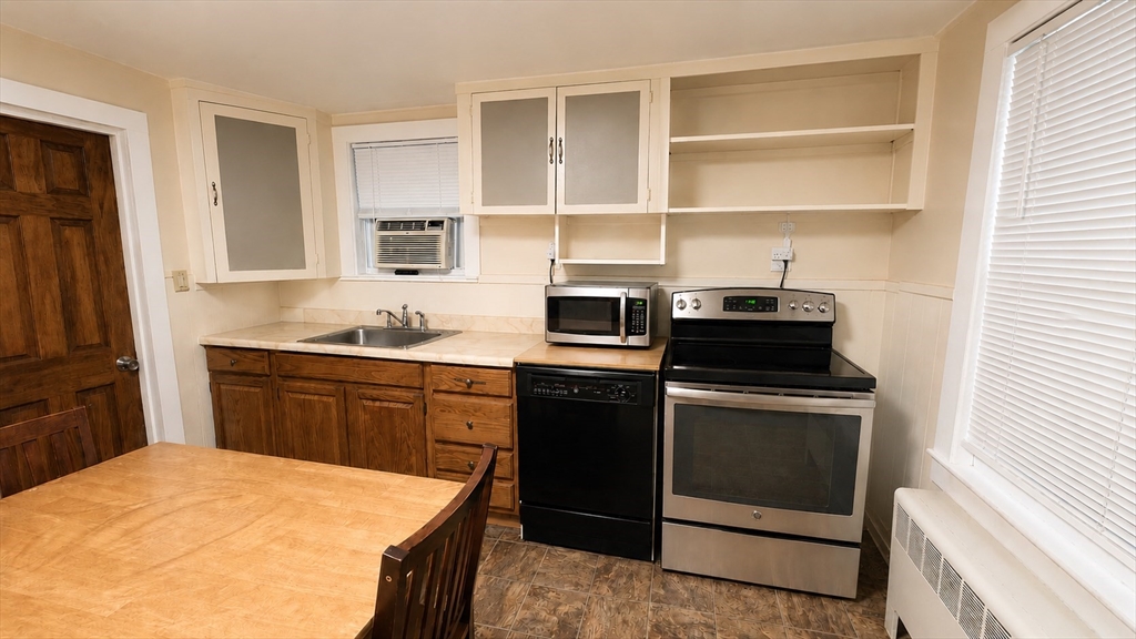 32 Birch Road Natick, MA 01760 - Photo 25 of 38 a kitchen with a stove microwave and refrigerator