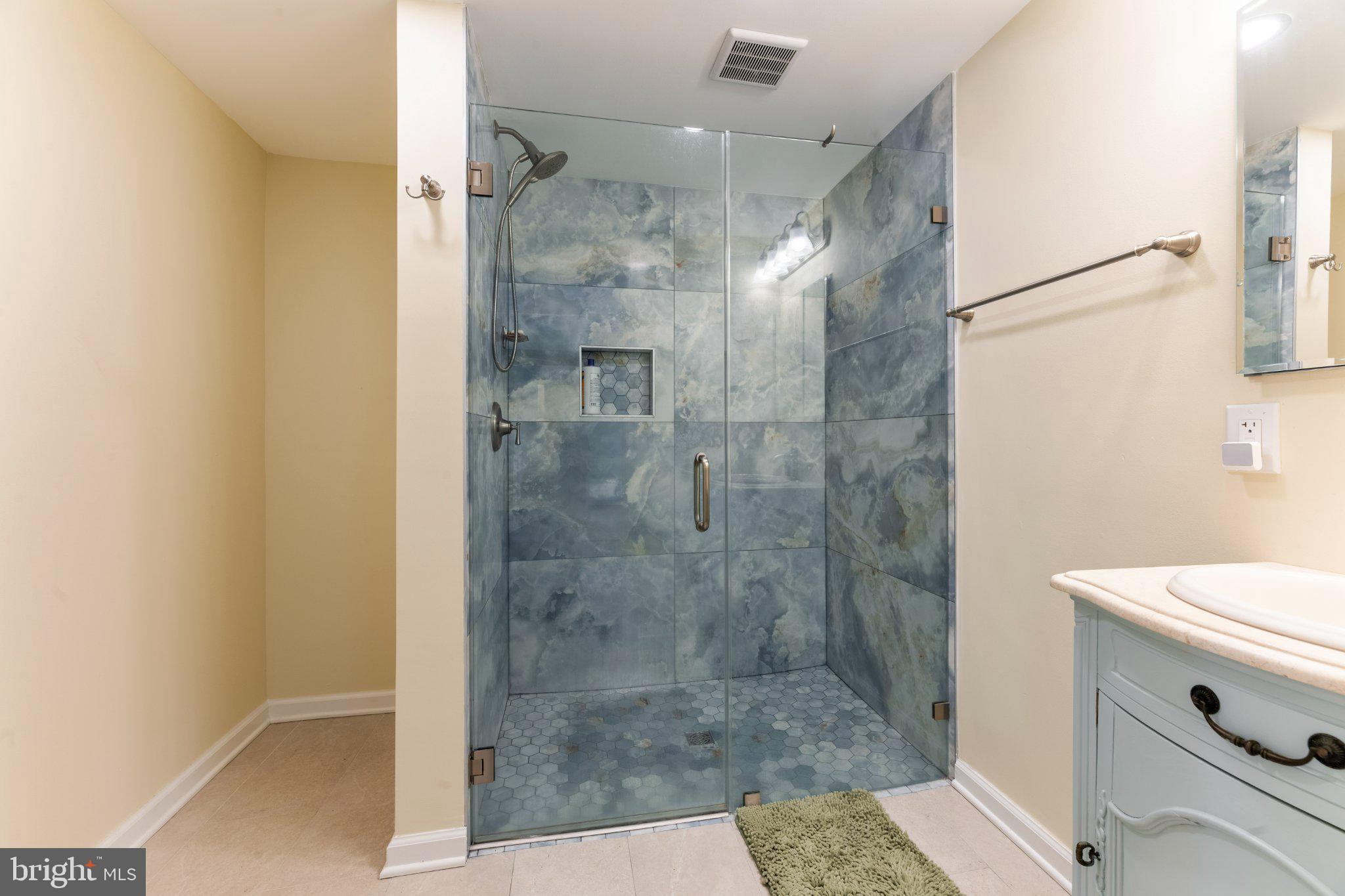 607 Chesterfield Arneytown Road Chesterfield, NJ 08515 - Photo 26 of 57 Sleek glass shower with serene tiles.