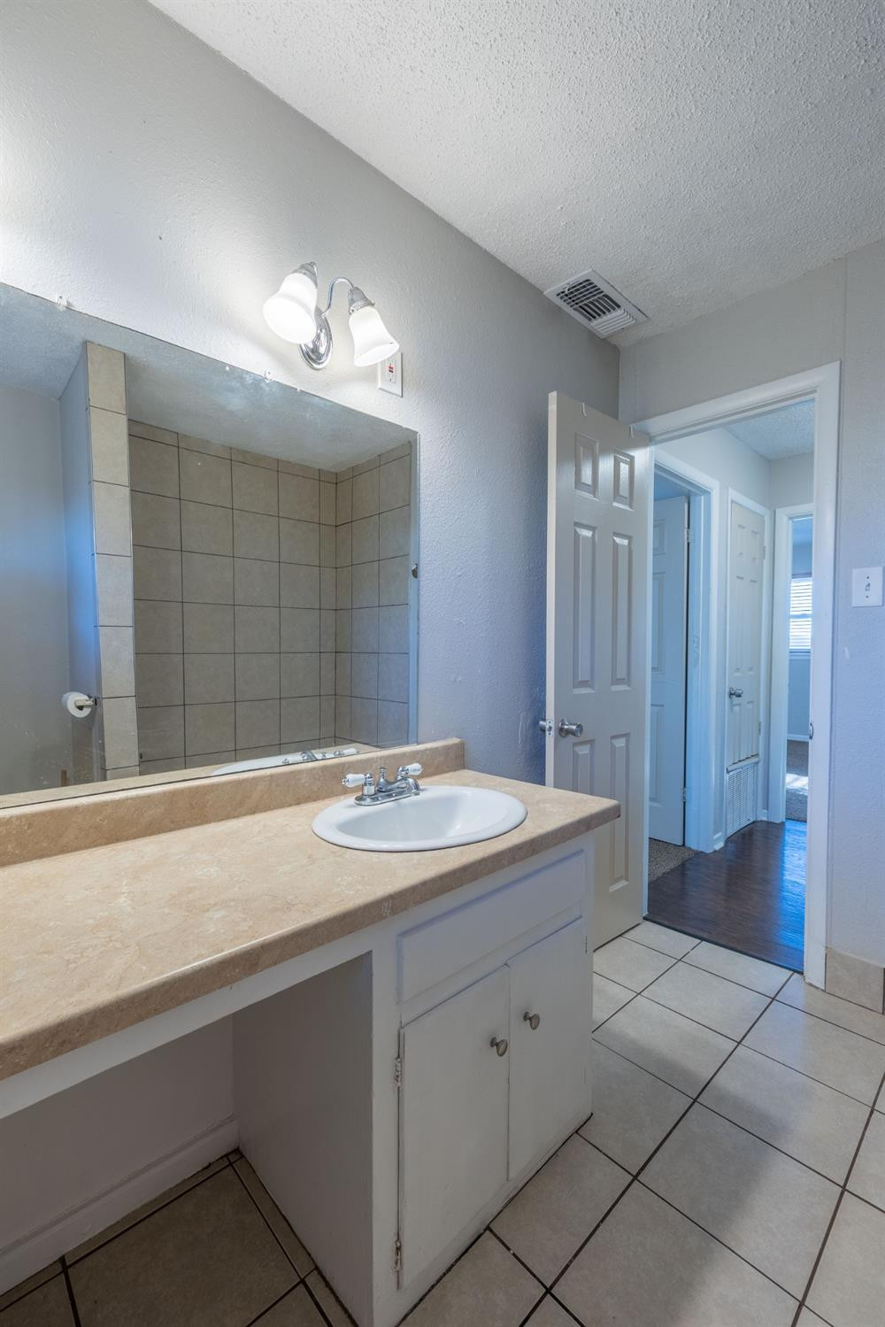 516 7th Street Wolfforth, TX 79382 - Photo 11 of 19 a bathroom with a sink double vanity and a mirror