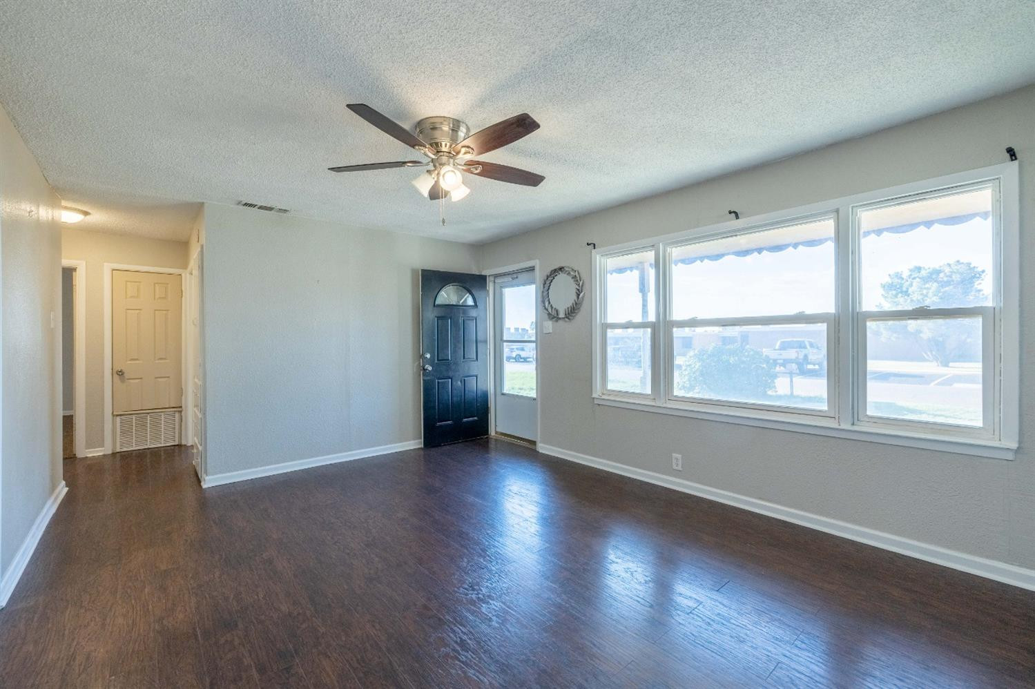 516 7th Street Wolfforth, TX 79382 - Photo 12 of 19 a view of an empty room with wooden floor and a window