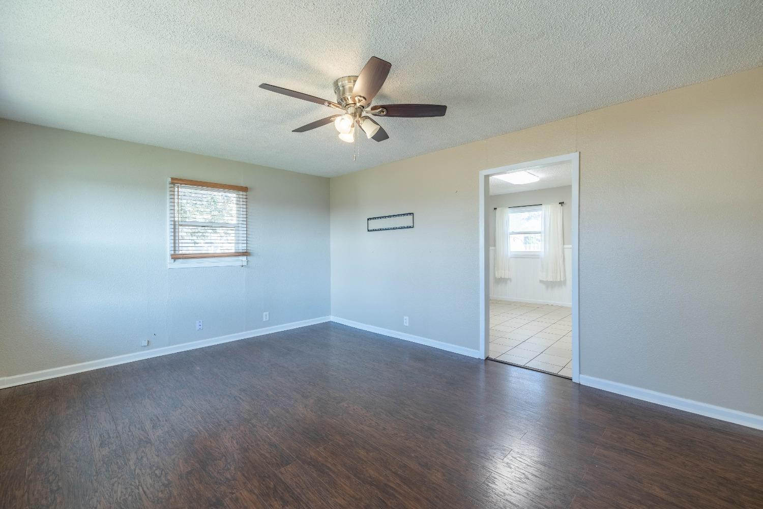 516 7th Street Wolfforth, TX 79382 - Photo 2 of 19 an empty room with wooden floor closet and windows