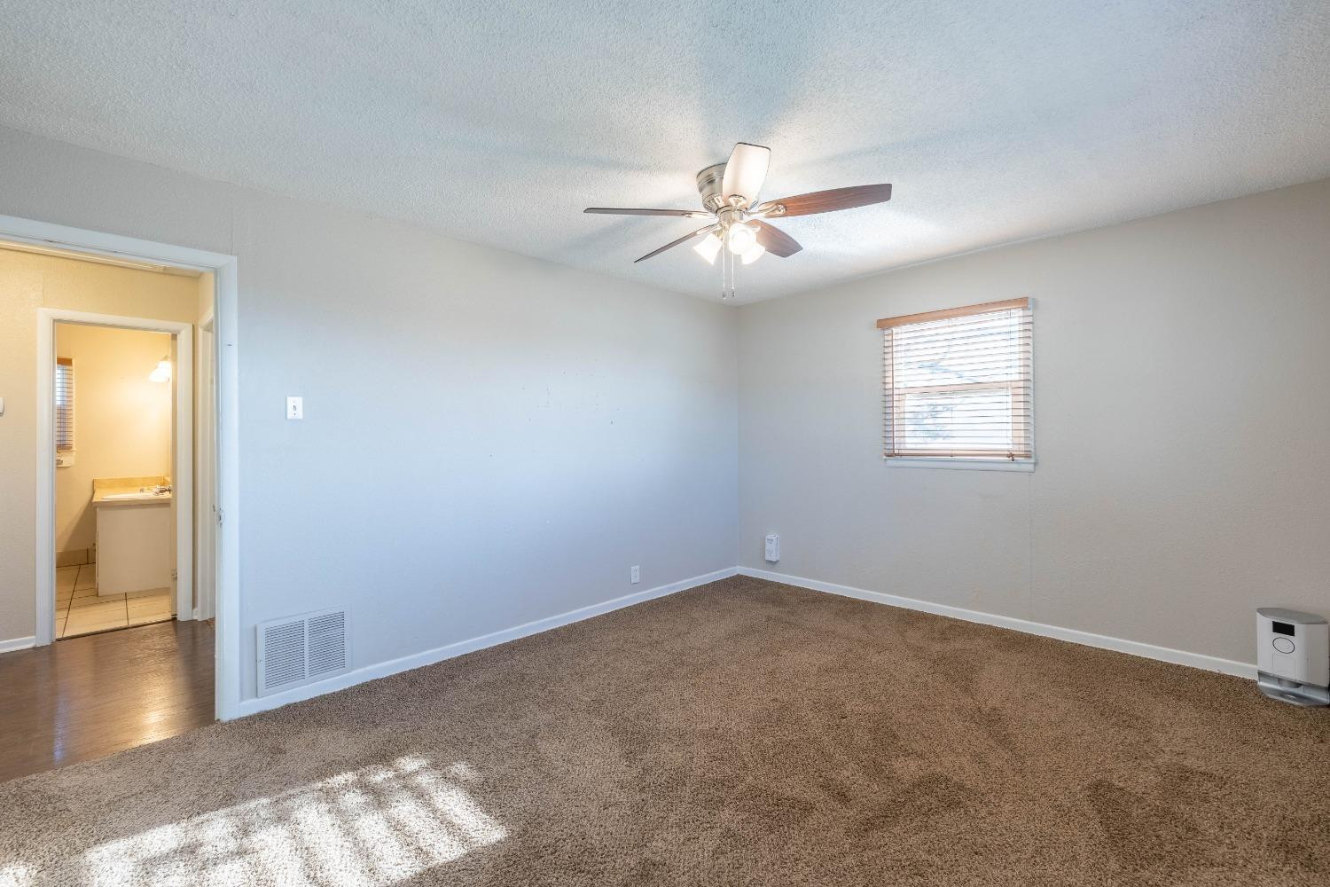 516 7th Street Wolfforth, TX 79382 - Photo 5 of 19 an empty room with windows and fan