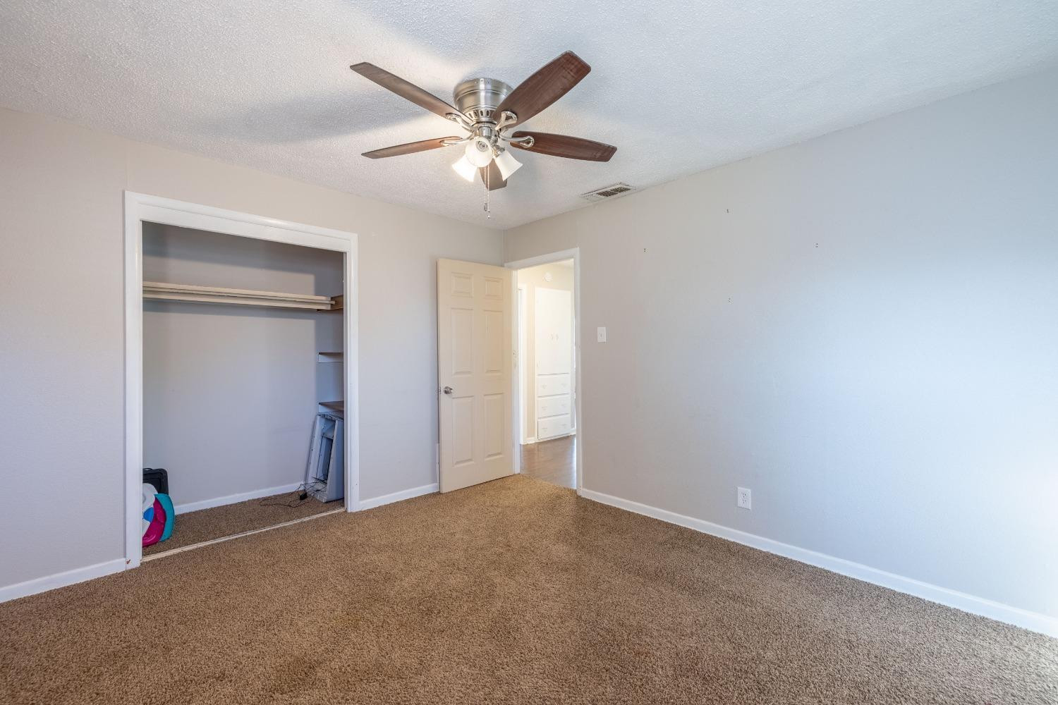 516 7th Street Wolfforth, TX 79382 - Photo 7 of 19 an empty room with closet and fan