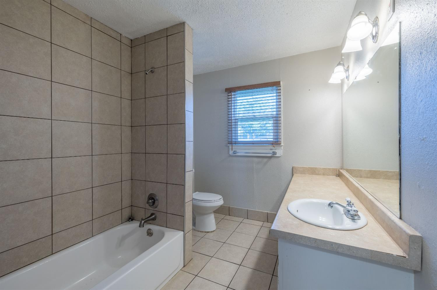 516 7th Street Wolfforth, TX 79382 - Photo 8 of 19 a bathroom with a sink a toilet and shower