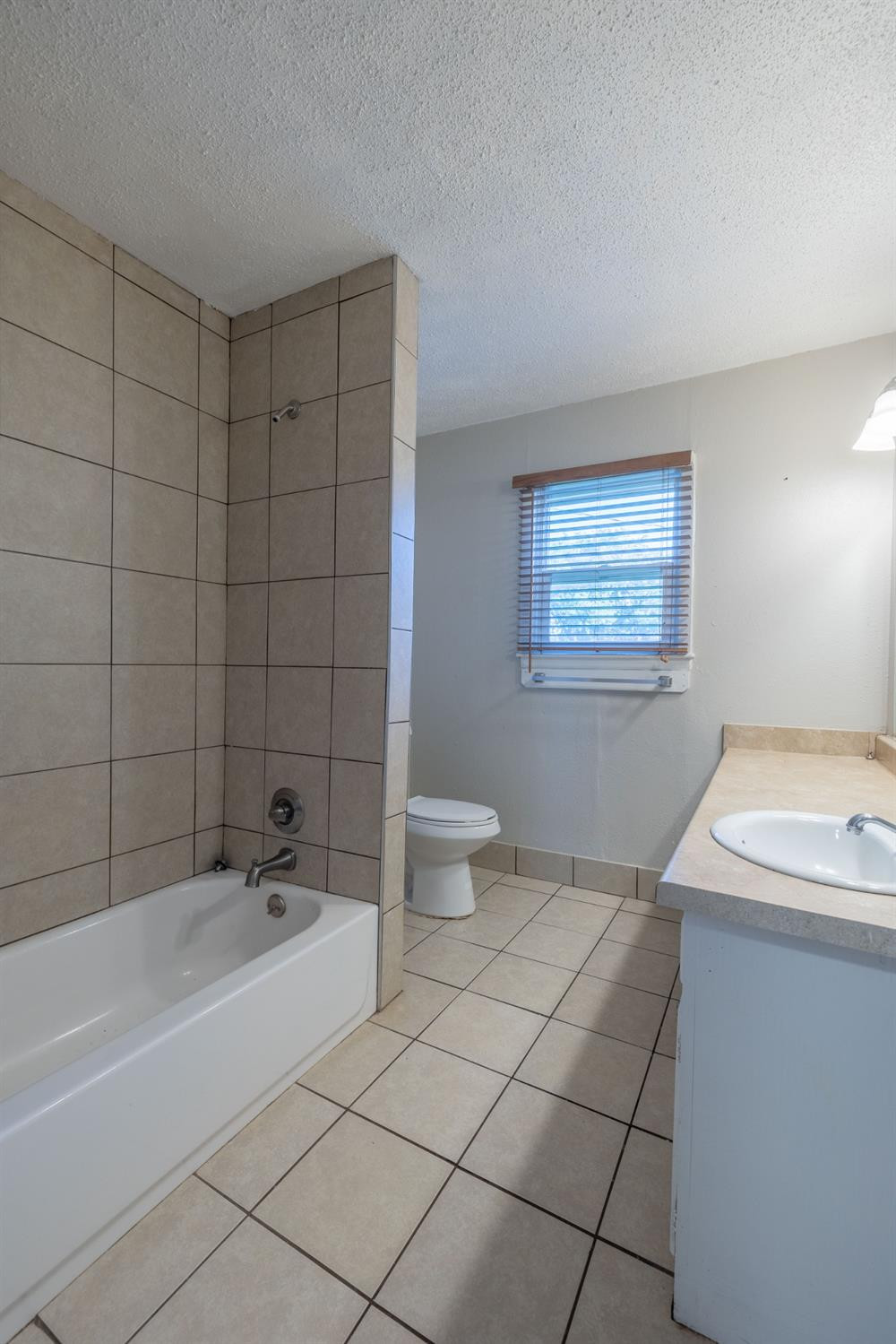 516 7th Street Wolfforth, TX 79382 - Photo 9 of 19 a bathroom with a sink a toilet and shower