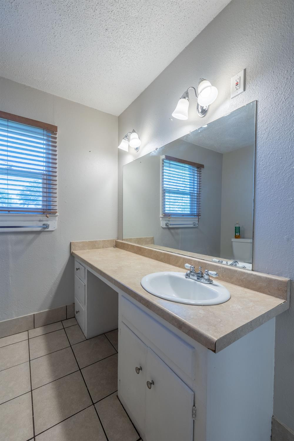 516 7th Street Wolfforth, TX 79382 - Photo 10 of 19 a bathroom with a sink a vanity and a mirror