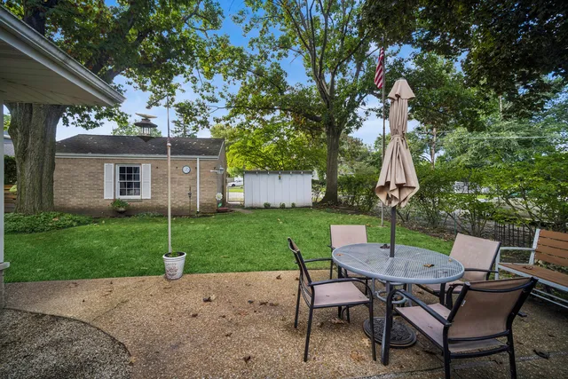 a view of a patio with a table and chairs