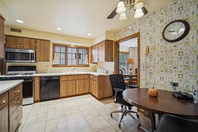 a large kitchen with a table and chairs in it