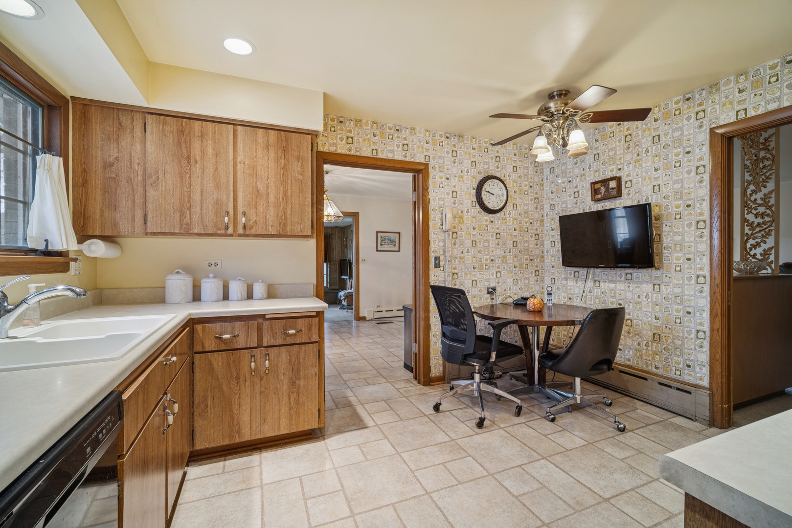 2239 Washington Avenue Wilmette, IL 60091 - Photo 6 of 20 a kitchen with stainless steel appliances a stove top oven a sink a dining table and chairs