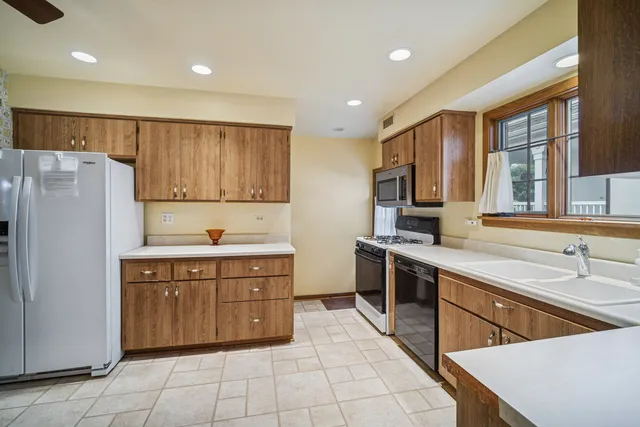 a kitchen with stainless steel appliances granite countertop a stove a sink dishwasher a refrigerator and a oven