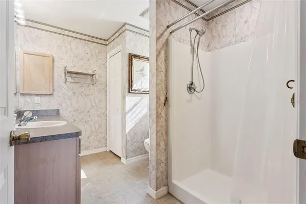 a bathroom with a shower and a sink