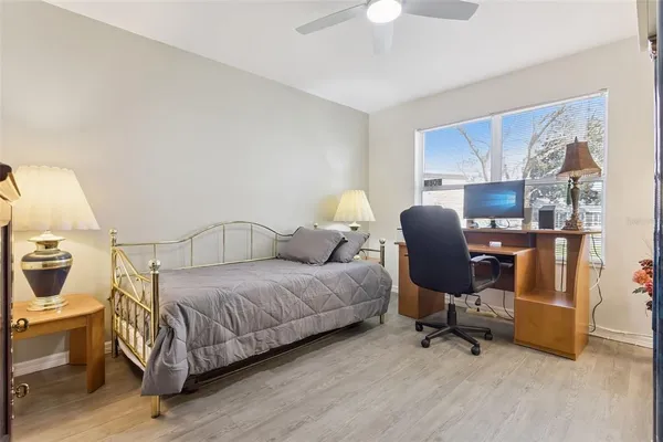 a bedroom with a bed and a chair