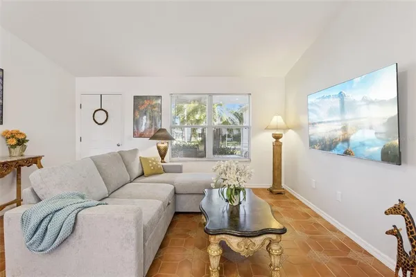 a living room with furniture and painting on the wall