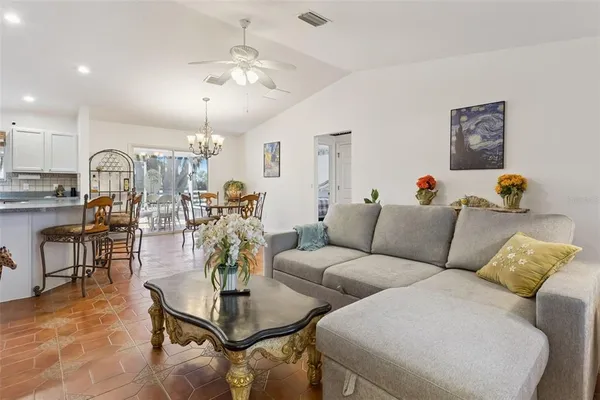 a living room with furniture and kitchen view