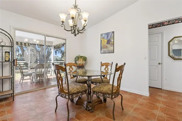 a view of a dining room with furniture and chandelier
