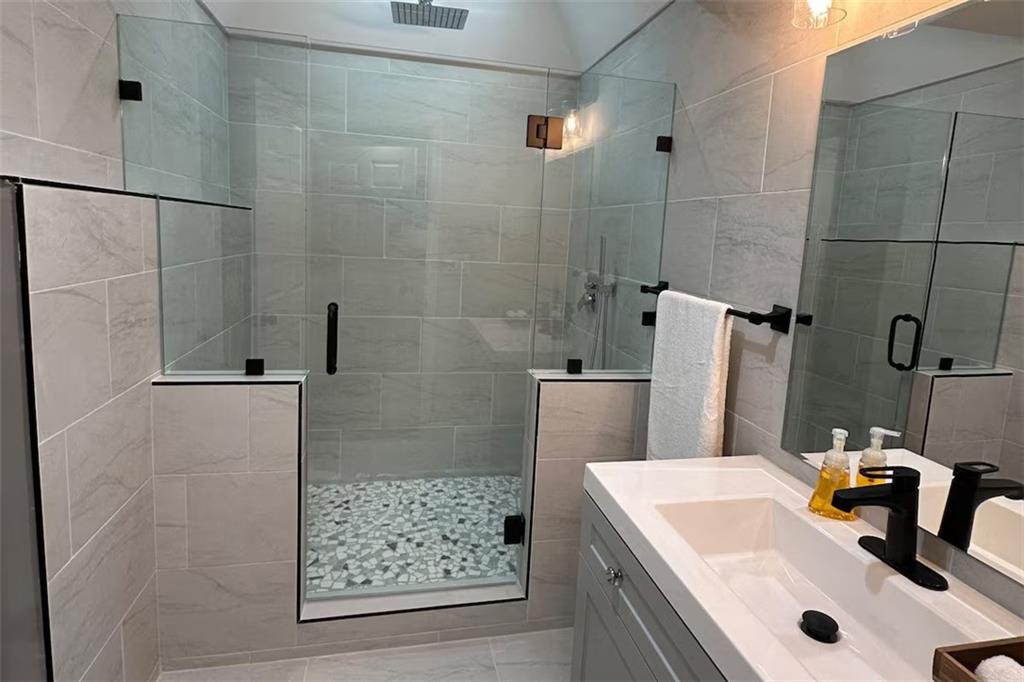 2251 Colonial Oak Way Southwest Stone Mountain, GA 30087 - Photo 14 of 32 a bathroom with a sink and a shower