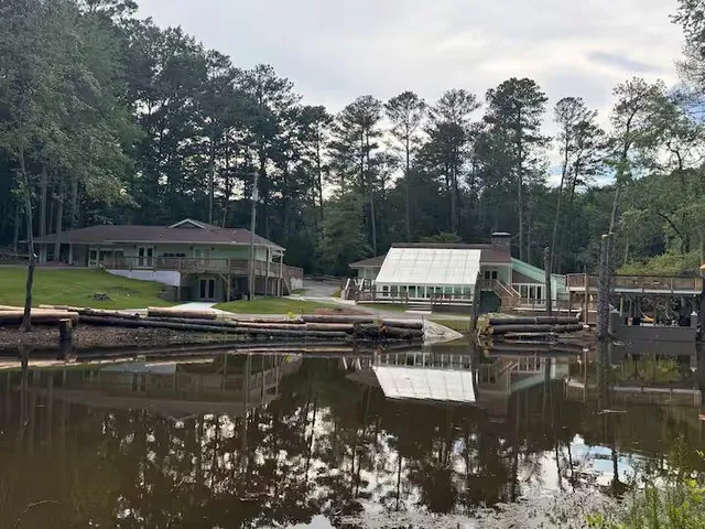 a view of an empty room with wooden floor and windows