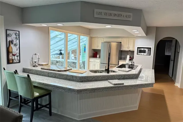 a living room with granite countertop furniture and a large window