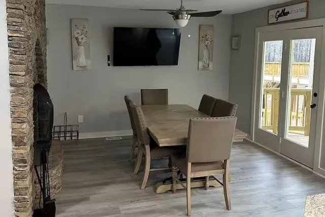 a view of a dining room with furniture and wooden floor