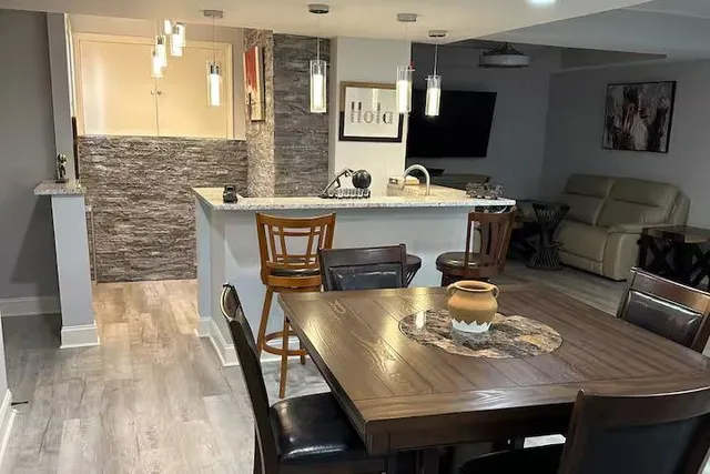 a view of a dining room with furniture and wooden floor