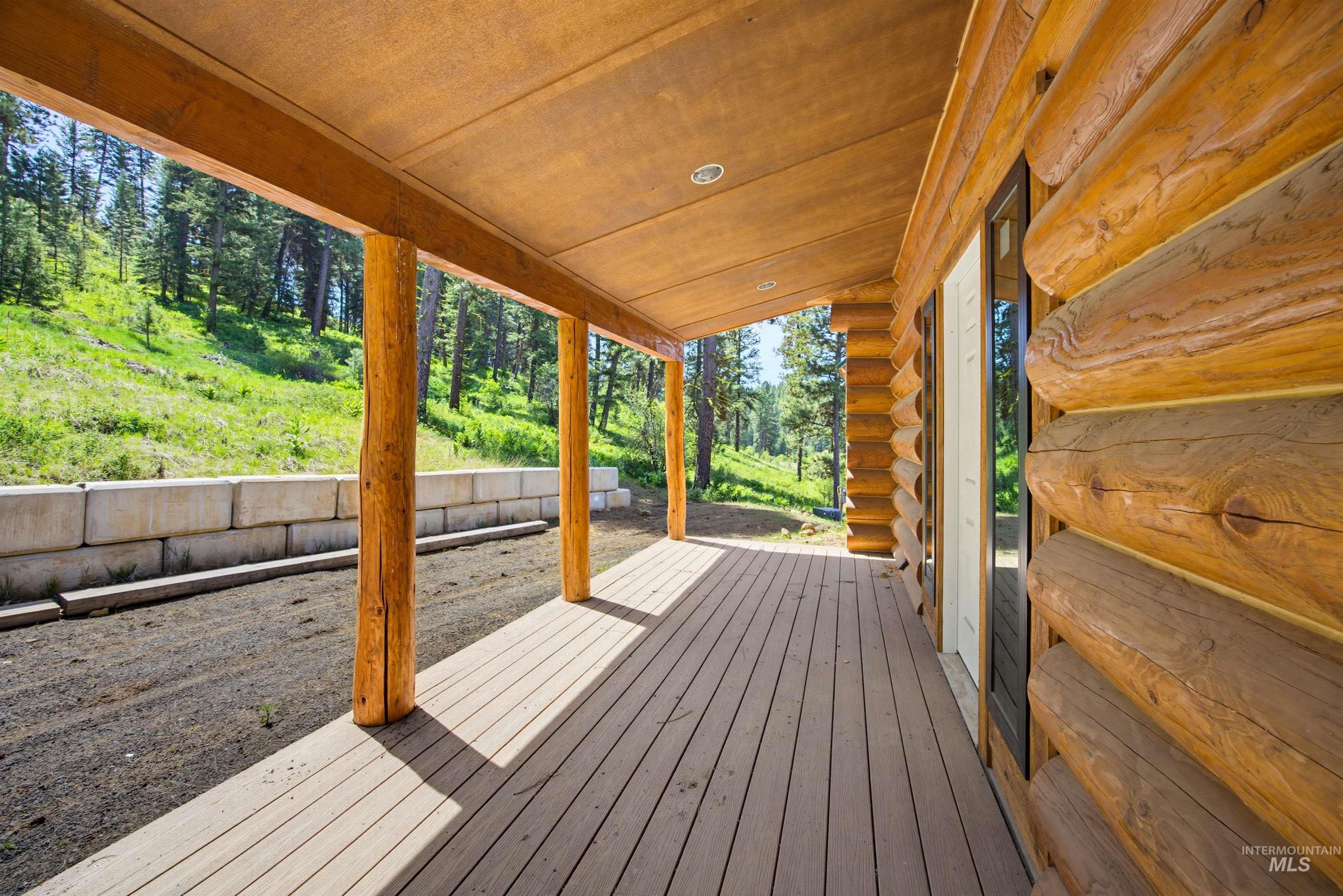 3322 Big Creek Road New Meadows, ID 83654 - Photo 20 of 50 Log cabin exterior with a covered porch featuring wood-finish decking, exposed wood beams, and recessed lighting