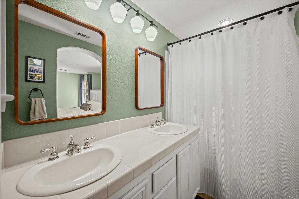 338 Kellogg Street San Marcos, CA 92078 - Photo 25 of 36 a bathroom with a double vanity sink and a mirror