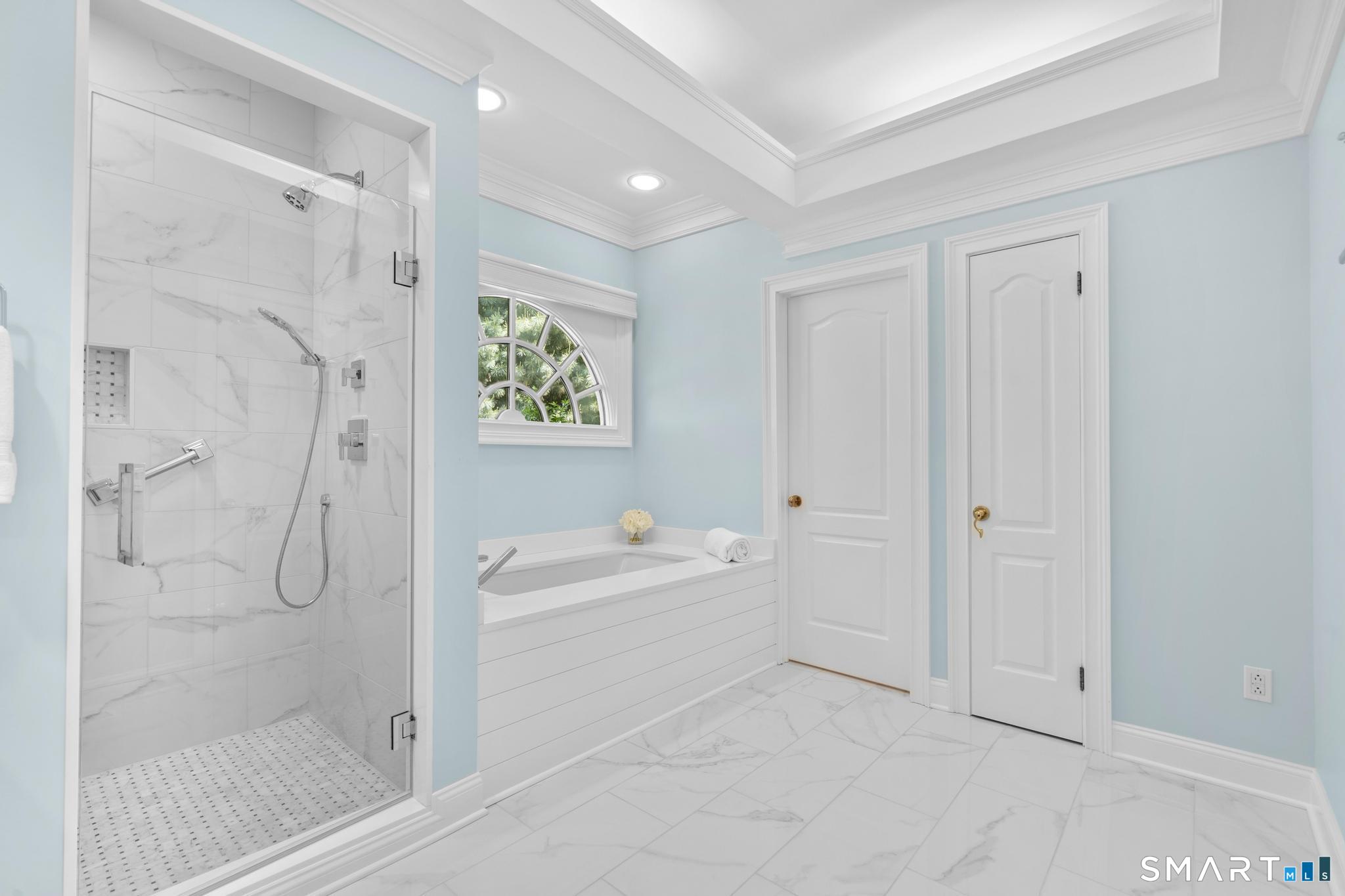 130 Stillson Road, Unit 130 Fairfield, CT 06825 - Photo 19 of 38 Updated spa-like primary ensuite bathroom with double vanity, stall shower, soaking tub, water closet, and linen closet