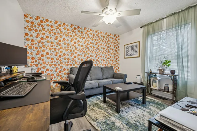 a view of a workspace with furniture and a flat screen tv