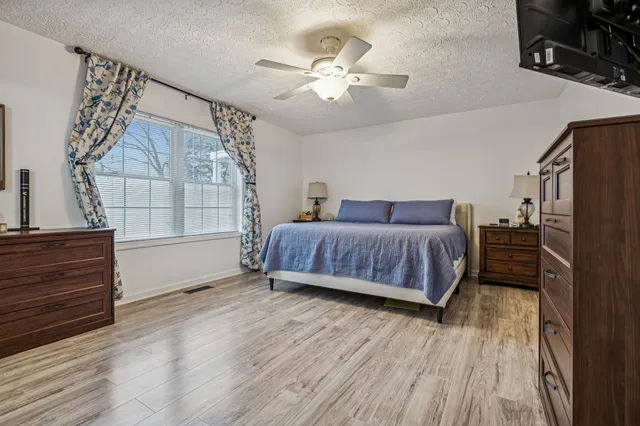 a living room with a bed furniture and a window